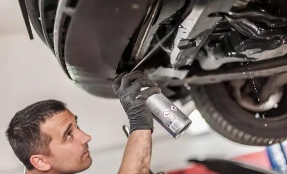 aster mechanic repairer lubricates the screws with a machine parts cleaner oil
