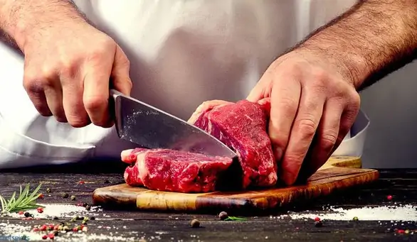 Man cutting beef meat