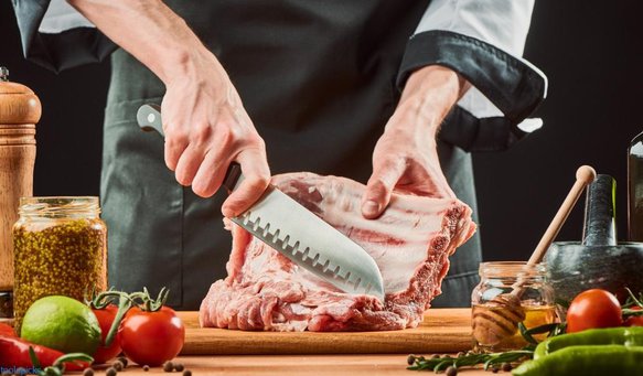 cutting raw ribs with a Santoku knife