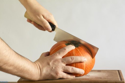 man chutting melon with nakiri knife