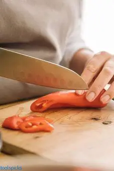 santoku knife cutting red chilli